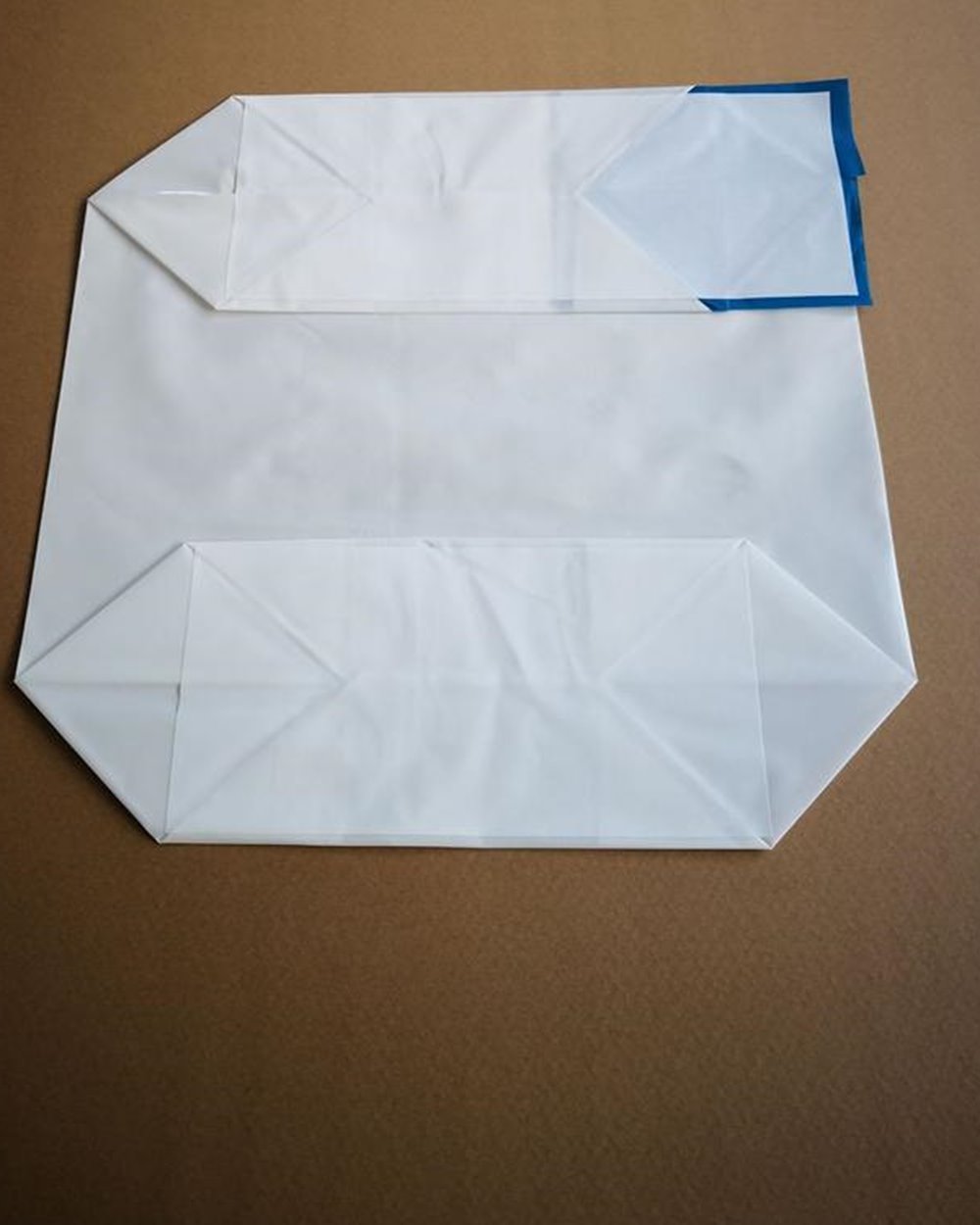 White PE valve bag on a brown work surface